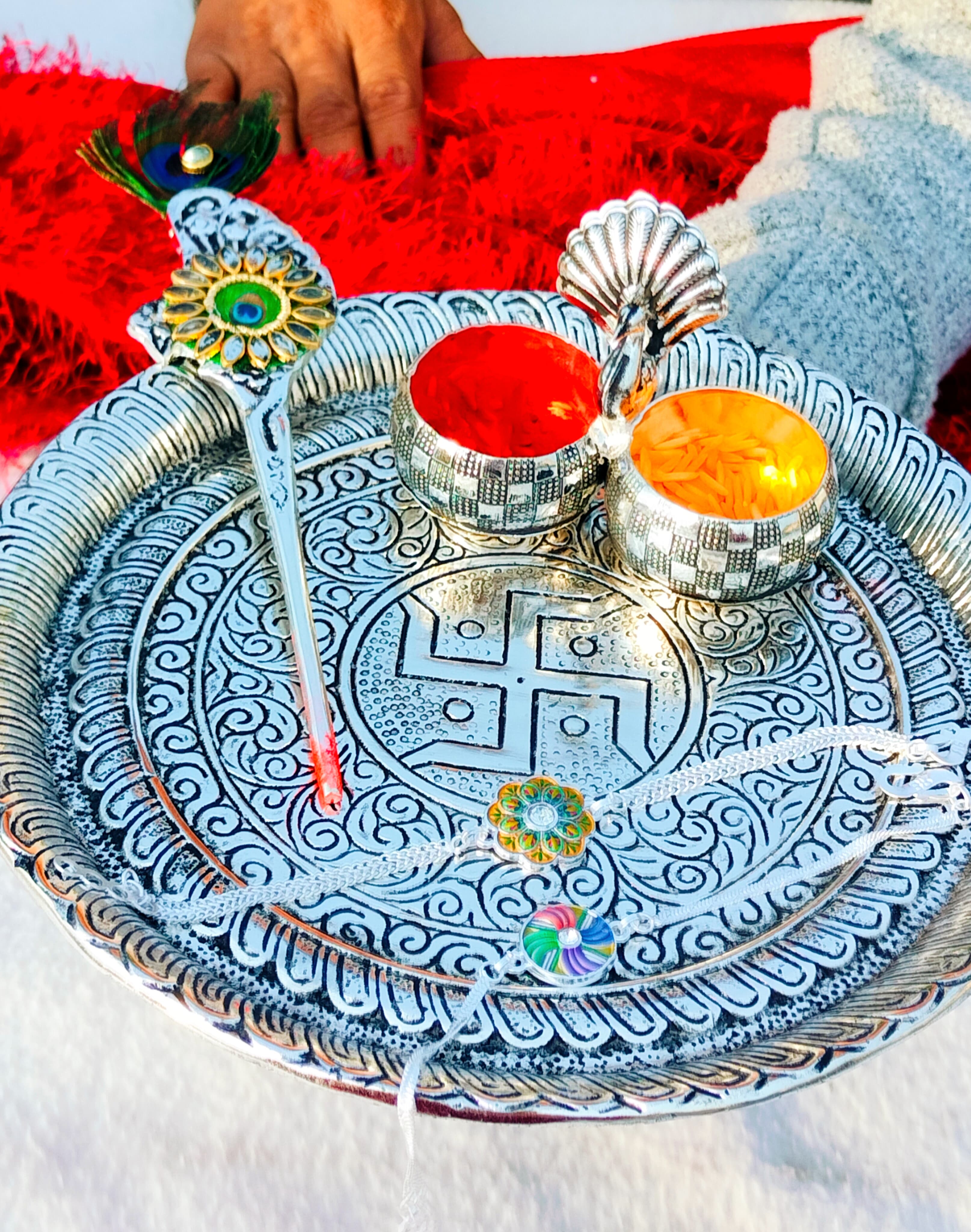 German silver Ghungaru thali with peacock kumkum bowl & tilak stick with 2 pure silver rakhi set